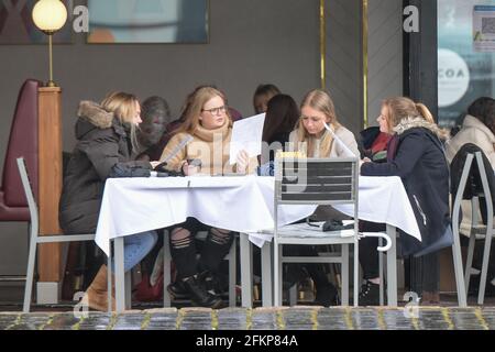 Gas Street Basin, Birmingham, West Midlands, Großbritannien. Mai 2021. Wind und Regen haben diese Leute nicht davon abgehalten, am Montag an Feiertagen in Noel's Bar und Restaurant zu essen. Die Besucher der zweiten Stadt Englands hüllten sich warm und kühl unter Regenschirmen, während sich der Regen seitwärts drehte und sie aus allen Richtungen traf. Sintflutartige Regenfälle haben viele Teile Großbritanniens getroffen, da die Menschen den ersten Bankfeiertag feiern, seit sich die Lockdown-Beschränkungen allmählich lockern. Quelle: Stop Press Media/Alamy Live News Stockfoto