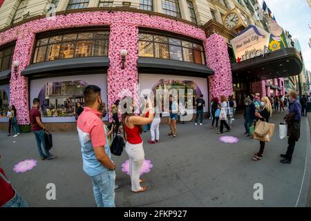 New York, USA. Mai 2021. Besucher vor Macy's Flagship-Kaufhaus am Herald Square in New York, das mit Blumenarrangements für die jährliche Macy's Flower Show am Eröffnungstag Sonntag, den 2. April 2021, behauen ist. Besucher strömen zur diesjährigen Show mit dem diesjährigen Thema, geben. Liebe. Bloom.'' die Show, die letztes Jahr aufgrund der Pandemie in einer Pause war, wurde entwickelt, um soziale Distanzierungen zu fördern. Die Show läuft bis zum 16. Mai. (ÂPhoto von Richard B. Levine) Quelle: SIPA USA/Alamy Live News Stockfoto