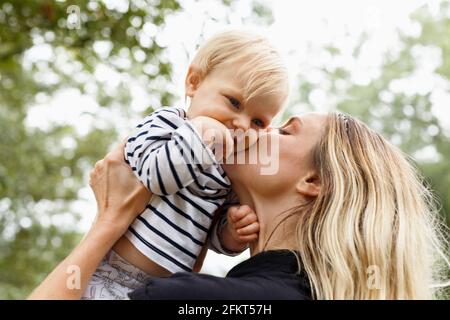 Mutter küssen Mädchen auf die Wange, im freien Stockfoto