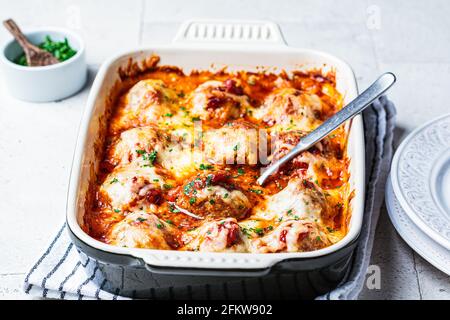 Gebackene kitschige Fleischbällchen Auflauf mit Tomatensauce in der Ofenform. Stockfoto