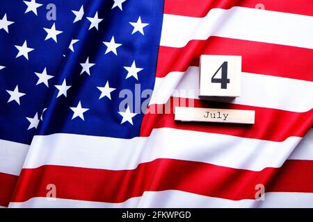 Rüschen amerikanische Flagge und holzwürfel Kalender mit 4. Juli, USA Independence Day Date, kopieren Raum celebratory Hintergrund. Uns patriotische festliche Co Stockfoto