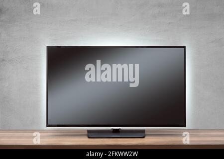 Fernseher mit schwarzem Bildschirm auf einer Holzoberfläche Stockfoto