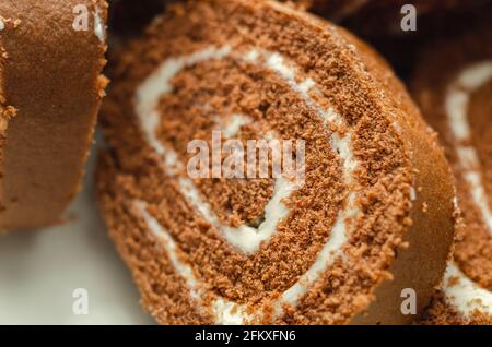 Schokoladen-Biskuitrolle mit Vanillegeschmack, Schweizer Schokoladenrolle, wirbelter Kuchen Stockfoto