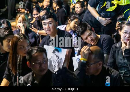 Trauernde in Schwarz mit Fotos von König Bhumibol bei der Trauerfeier in Bangkok, Thailand Stockfoto