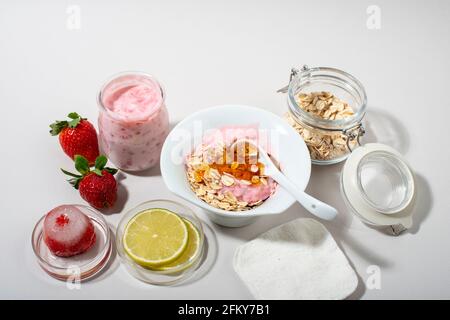 Hausgemachte Erdbeer Gesichtsmaske Zutaten: Erdbeere, Joghurt, Honig, Zitrone, Haferflocken. DIY hausgemachte natürliche Hautpflegeprodukte. Stockfoto