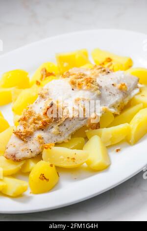 zander auf Knoblauch serviert mit gekochten Kartoffeln Stockfoto