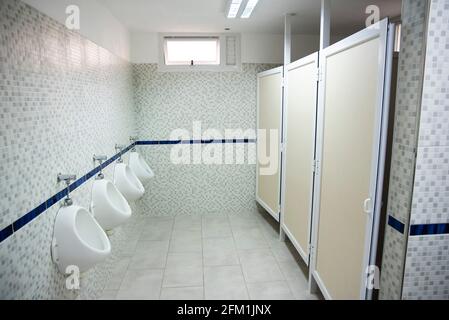 Modernes prívate Schulbad, mit neuen Fliesen, Waschbecken, Toilettenpapier. Stockfoto
