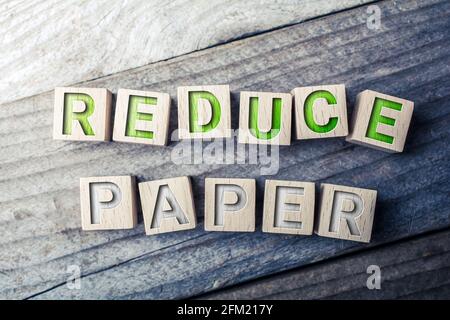 Reduzieren Sie das Papier, das auf Holzblöcke auf einem Brett geschrieben wird - Konzept „Save Trees“ Stockfoto