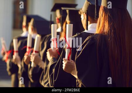 Graduate.Selective Fokus auf Graduation Student in akademischen Cap und Kleid Diplom halten Stockfoto