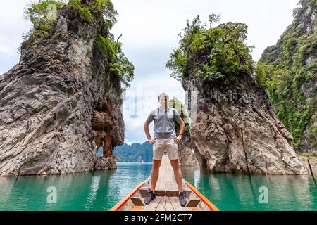 Glücklicher junger Tourist im Longtail Boat in der Nähe der berühmten drei Felsen Stockfoto