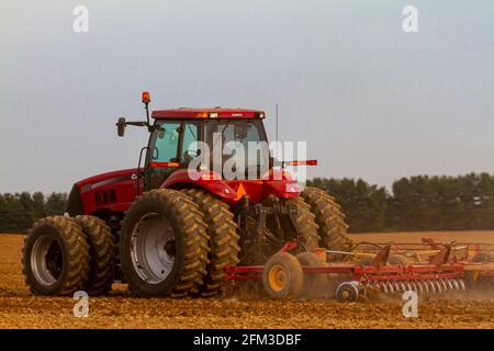 Chestertown, MD, USA 05-02-2021: Roter Sechsradkoffer IH Magnum 305 mit Kabine pflügt im Frühjahr ein leeres Agrarfeld. Der Pflug A Stockfoto