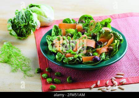 Kichererbensalat mit Salat, Oliven, Pinienkernen und Karotten Stockfoto
