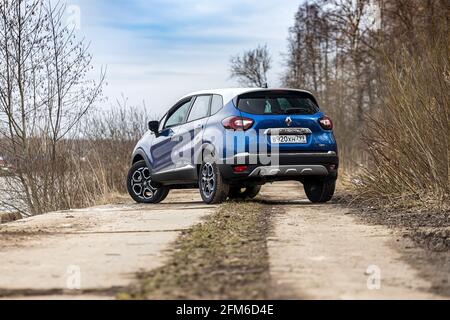 Moskau, Russland - 11. April 2021: Blauer Renault Kaptur mit grauem Dach. Die zweifarbige Kompaktkreuzung wird auf der Straße in Flussnähe geparkt. Rückansicht Stockfoto