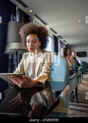 Gerne schwarz Geschäftsfrau mit Tablet Computer im Coffee Shop Stockfoto