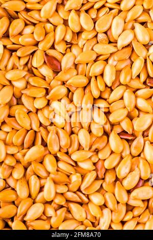 Hintergrund Textur von gerösteten goldenen Leinsamen oder Leinsamen mit gesunden Omega-3-Fettsäuren, Ballaststoffe, reich an Ölen und verwendet, um Cholesterin zu senken Stockfoto