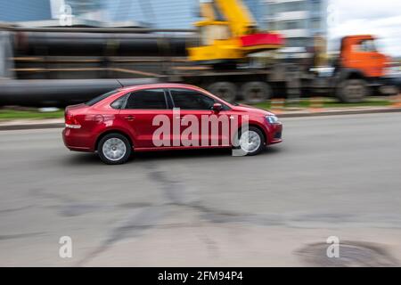 Ukraine, Kiew - 26. April 2021: Rotes Volkswagen Polo-Auto fährt auf der Straße. Redaktionell Stockfoto