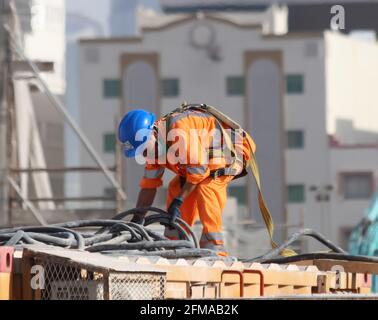 Blick auf die Arbeit der Arbeitnehmer unter heißen Wetterbedingungen in Doha, Katar. Stockfoto