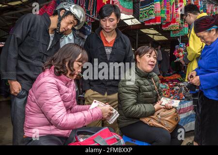 Schwarzmarkt, Geldwechsel zwischen chinesischem und vietnamesischem Geld, Dong Van ethnischer Minderheitsmarkt, hauptsächlich H'mong, Provinz Ha Giang, Nordvietnam Stockfoto