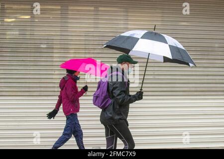 Hund mit Plastikbeutel bedeckt Preston, Lancashire, UK. Mai 2021. UK Wetter; nasser und windiger Tag im Stadtzentrum. Es wird erwartet, dass die Südwinde im Laufe des Tages mildere Temperaturen bringen werden. Credit MediaWorldImages/AlamyLiveNews Stockfoto