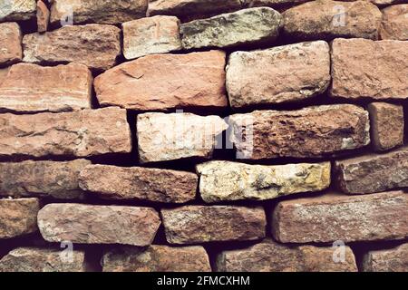 Hintergrund Steinwand aus roten Steinen Stockfoto