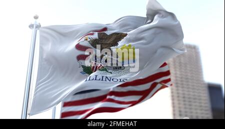 Die Staatsflagge von Illinois flatternd im Wind, die amerikanische Nationalflagge verschwimmt im Hintergrund. Demokratie und Unabhängigkeit. Amerikanischer mittlerer Westen Stockfoto