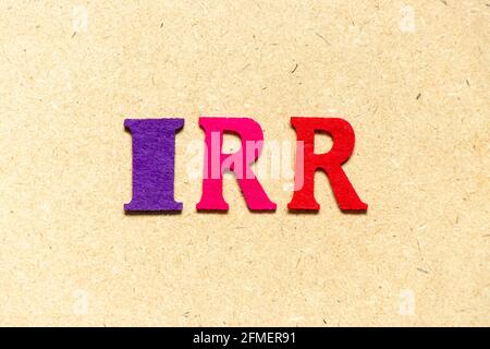 Color cloth alphabet letter in word IRR (Abbreviation of internal rate of return) on wood background Stockfoto