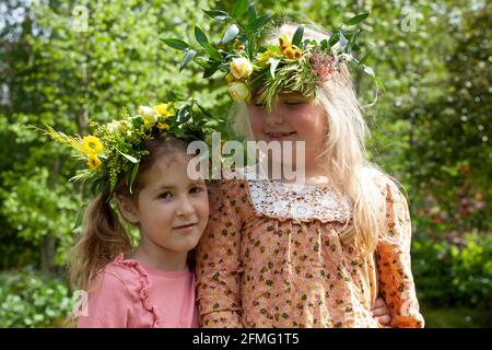 London, Großbritannien, 9. Mai 2021: Die Cousins Hippolita, 5 Jahre alt, und Minerva, 8 Jahre alt, mit den Blumenkronen, die sie zur Feier des Garden Day angefertigt haben. Diese Veranstaltung fand im Chelsea Physic Garden statt und wurde von Floristin Fran Bailey von der Fresh Flower Company geleitet. Anna Watson/Alamy Live News Stockfoto