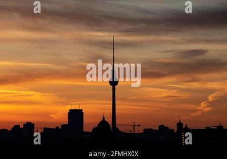 Berlin, Deutschland. Mai 2021. Am frühen Morgen wird der Himmel hinter dem Fernsehturm orange. Quelle: Fabian Sommer/dpa/Alamy Live News Stockfoto