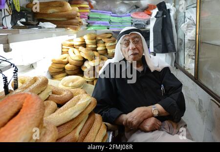 Ein Palästinenser, der Ka'ak-Brot aus seinem kleinen Laden im muslimischen Qt. In der Altstadt von Jerusalem verkauft. Stockfoto