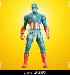 Toy Captain America steht in Pose vor einem gelb hinterleuchteten Hintergrund. Vorderansicht. 3d-Rendering Stockfoto