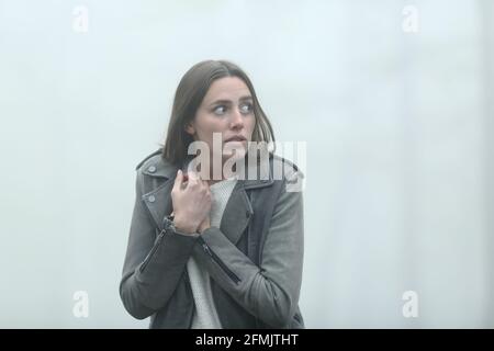 Angst Casual Frau allein zu Fuß Blick auf Seite in einem Nebliger Park Stockfoto