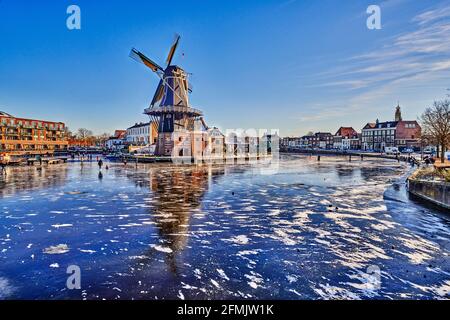 Niederlande, Haarlem - 17-03-2021: Winterlandschaft, Windmühle mit Schnee und Eis Stockfoto