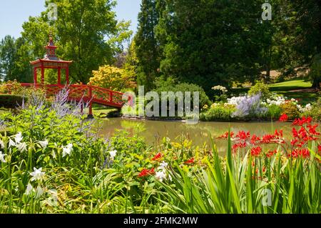 Blumenpark und Gärten mit roter chinesischer Pagodenbrücke im malerischen Dorf Apremont-sur-Allier, das als eines der schönsten Dörfer aufgeführt ist Stockfoto