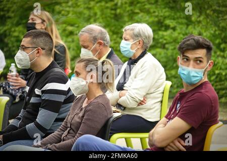 Das Publikum, das Covid-Masken trägt, spielt zunächst in einem Outdoor-Park zur Wiedereröffnung nach der Pandemie. Mailand, Italien - Mai 2021 Stockfoto