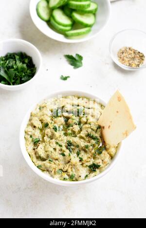 Baba ganoush (geröstete Auberginen-Dip) In Schale über hellem Stein Hintergrund Stockfoto