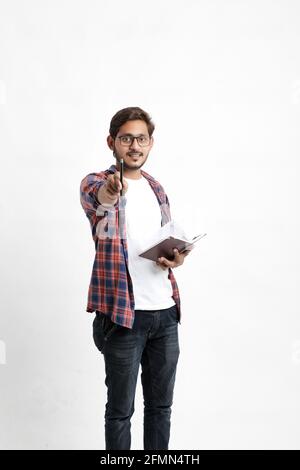 Bildungskonzept : Indischer College-Student mit Tasche und zeigt Notizbuch auf weißem Hintergrund. Stockfoto