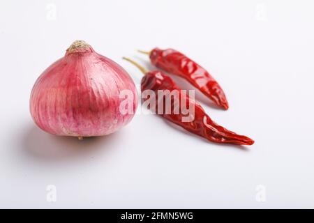 Trockene rote Chili und Zwiebel auf weißem Hintergrund. Stockfoto