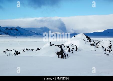Schnee und Eis Winter Blick über die Burfelshraun Gegend in der Nähe Nach Hevrir in Nordost-Island, einschließlich Freileitungen für die Stromversorgung In der Ferne Stockfoto