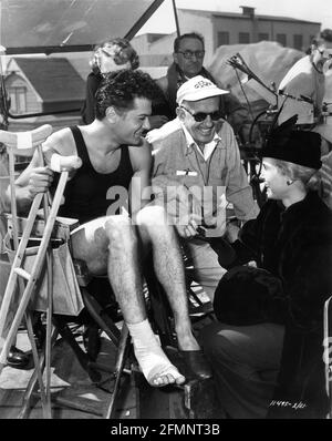 TONY CURTIS im Kostüm als Harry Houdini (mit verstauchter Knöchel) Und seine Frau und Co-Star JANET LEIGH am Set offen Mit Regisseur GEORGE MARSHALL und Movie Crew während der Dreharbeiten von HOUDINI 1953 Regisseur GEORGE MARSHALL Buch Harold Kellock Drehbuch Philip Yordan Produzent George Pal Paramount Pictures Stockfoto