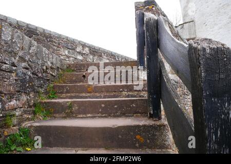 Alte Steintreppe mit altem schwarzen Holzgeländer als Zugang Zur Verteidigungsmauer einer mittelalterlichen Burg in europa Stockfoto