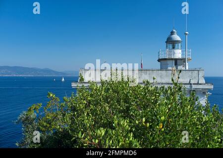 Historischer Leuchtturm von Portofino, Ligurien, Italien an der italienischen Riviera mit Blick auf den Ozean unter grünen Bäumen Stockfoto