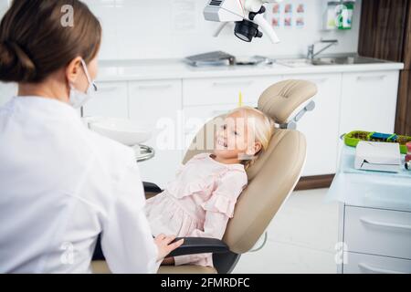 Eine junge Zahnärztin, die eine gründliche Untersuchung der Zähne ihres Patienten durchführt. Stockfoto