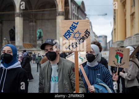 Demonstrant hält Schild mit der AUfschrift: „ Israel Terrorist “. Ca. 1000 Menschen sammeln sich am 11. Mai in München spontan, um ihre Solidarität mit den palästinischen Demonstrant*innen in Jerusalem zu zeigen. Da deutlich mehr Menschen als zur Sammlung kamen, müssen die Polizei sie auf. The Demonstrant*innen verschließen friedlich die Kundgebung. * Demonstrantor hält ein Schild mit der Aufschrift: ' Israel Terrorist '. Am 11 2021. Mai versammelten sich spontan rund 1000 Menschen in München, um ihre Solidarität mit den palästinensischen Demonstranten in Jerusalem zu zeigen. Die Polizei dissol Stockfoto