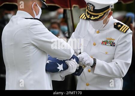 Swoyersville, Usa. Mai 2021. Maskierte Navy-Mitglieder überprüfen die amerikanische Flagge, bevor sie sie der Familie des Veteranen des Zweiten Weltkriegs, Sam Greenberg, während der Beerdigung überreichen. Kredit: SOPA Images Limited/Alamy Live Nachrichten Stockfoto