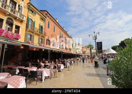 ITALIEN, VENETIEN, VERONA - 15. SEPTEMBER 2019: Die Restaurants in bunten Häusern auf der Piazza Bra sind Einladungen zu einem Aufenthalt Stockfoto