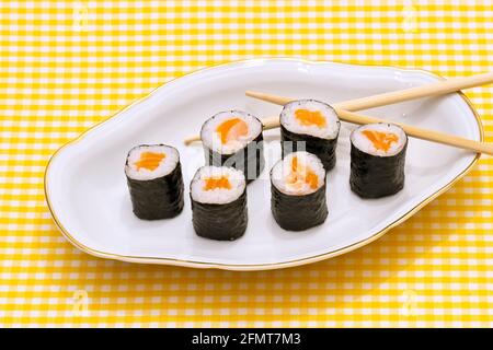 Makizushi. Köstliche Sushi-Rollen auf weißen Teller mit Stäbchen und Wasabi. Maki Stockfoto