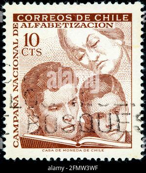 CHILE - UM 1966: Eine in Chile gedruckte Briefmarke aus der Ausgabe 'Education Campaign' zeigt Lernen, um 1966 Stockfoto