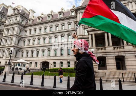 Washington, DC, USA, 11. Mai 2021. Im Bild: Ein Demonstranten trägt eine palästinensische Flagge, als er während eines marsches das Exekutivbüro und das Büro des Vizepräsidenten passiert, der die Vereinigten Staaten auffordert, die Finanzierung von Apartheid, Besatzung und Gewalt in Palästina einzustellen. Kredit: Allison C Bailey / Alamy Live Nachrichten Stockfoto