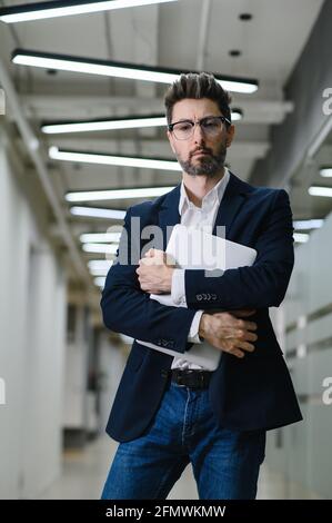 Junge Geschäftsmann im Büro arbeiten online auf Laptop lösen Geschäftsproblem. Nachdenkliche Geschäftsmann verwenden Computer denken über Projekt nachdenken. Stockfoto
