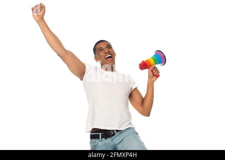 Aufgeregter afroamerikanischer Mann, der eine Siegegeste zeigt, während er lgbt hält Farben Megaphon isoliert auf weiß Stockfoto